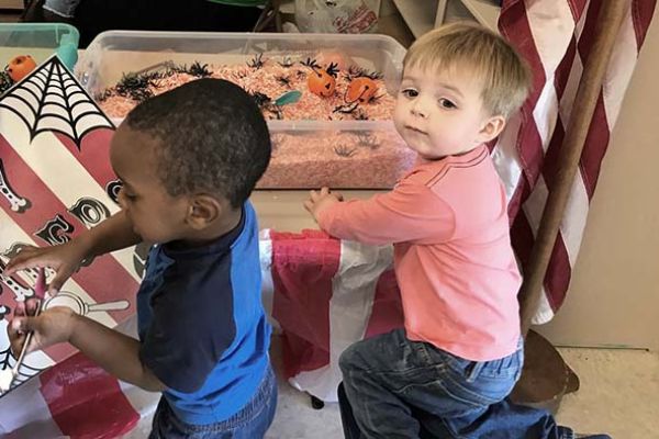 two little boys decorating for Halloween